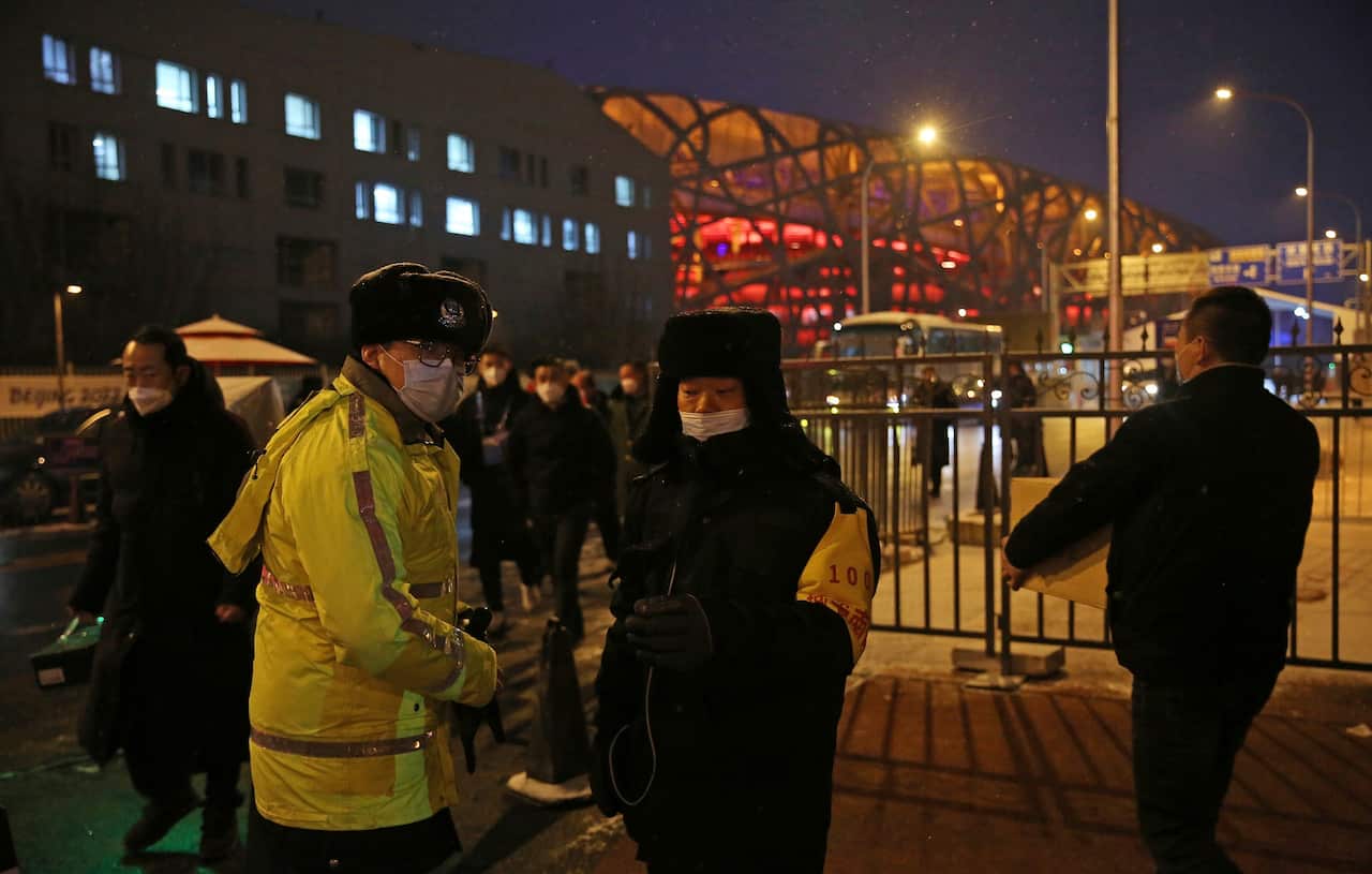 Security guards watch at a gate of restricted area in Beijing on 21 January 2022. 