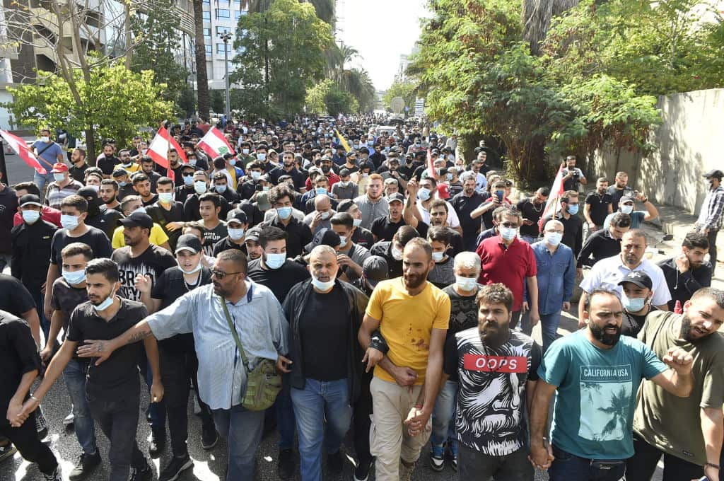 Hundreds of supporters of the Shia group Amal Movement and Hezbollah gather during a protest held to demand the dismissal of judicial investigator Tarek Bitar.