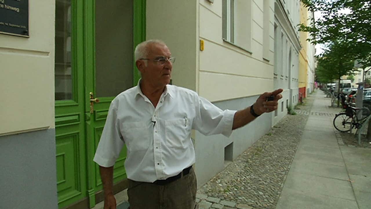 Hasso Herschel describes the barrier that once divided this street, as he stands outside the house where his escape tunnel came out.