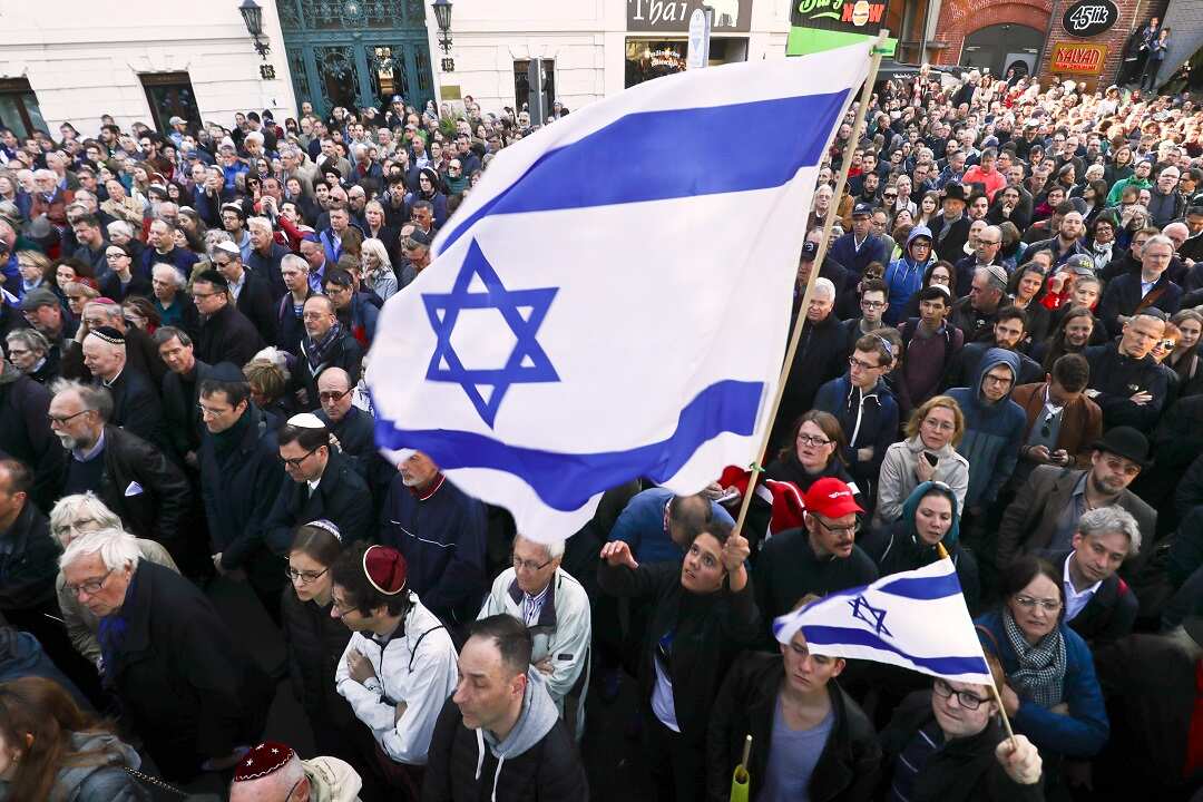 People wave flags of Israel while taking part in the "Berlin Wears Kippa" rally in solidarity with the Jewish Community on Wednesday.