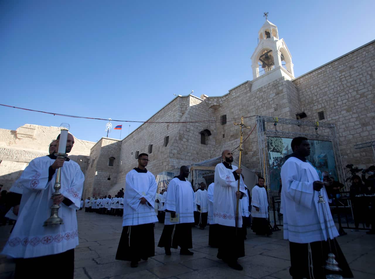 Clergymen attend Christmas celebrations outside the Church of the Nativity.