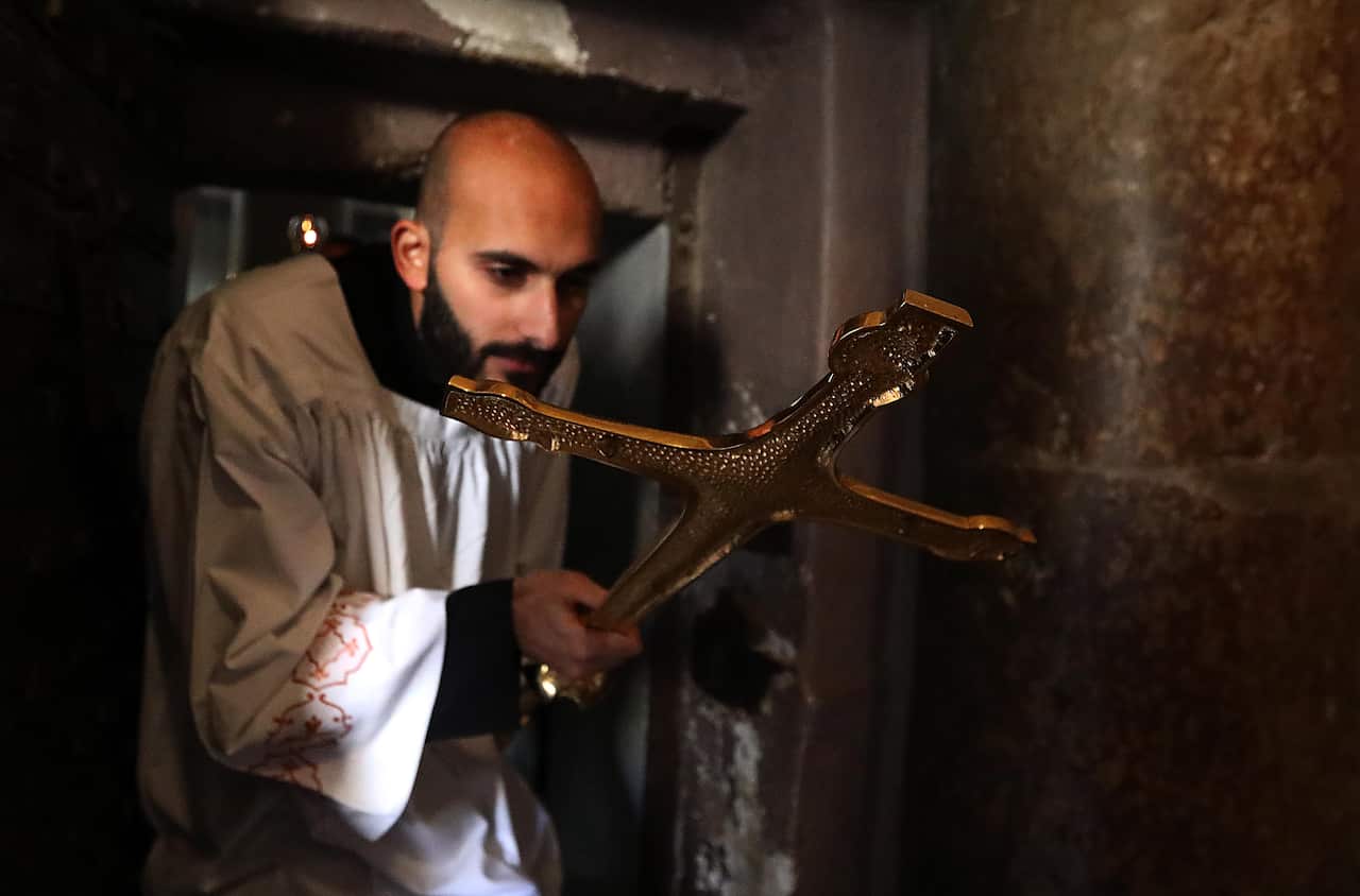 Clergymen arrive for a mass at the Church of the Nativity on Christmas Eve.