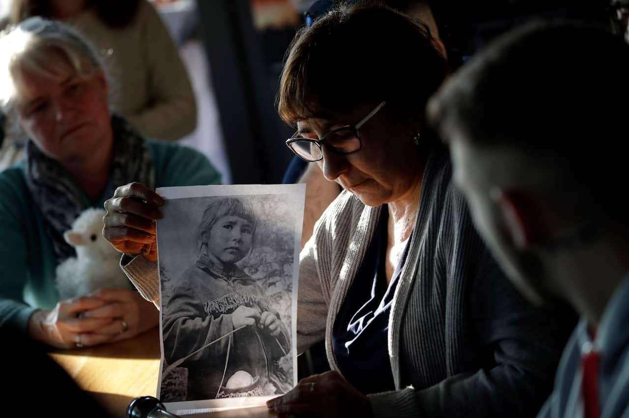 Sex abuse survivor Evelyn Korkamaz, holding a photo photo of her when she was a child at a press conference of members of the Ending Clergy Abuse.