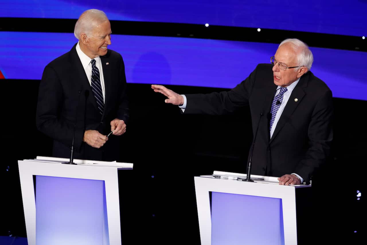 Democratic presidential candidate Bernie Sanders speaks as former Vice President Joe Biden looks on during the debate.