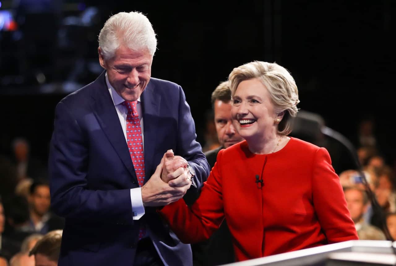 Democratic presidential nominee Hillary Clinton walks off the stage with her husband former President Bill Clinton after the presidential debate
