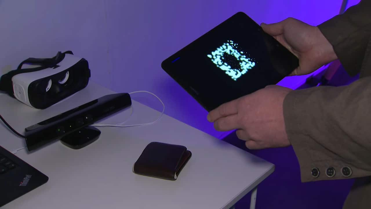 Dr Chris McCarthy demonstrated how his wallet would look to a wearer of the bionic eye.