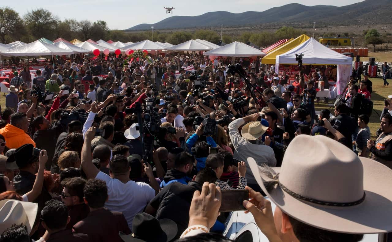 Rubi Ibarra arrives at the site of a Mass that is part of her down-home 15th birthday party, surrounded by a horde of journalists and a drone flying (AAP)