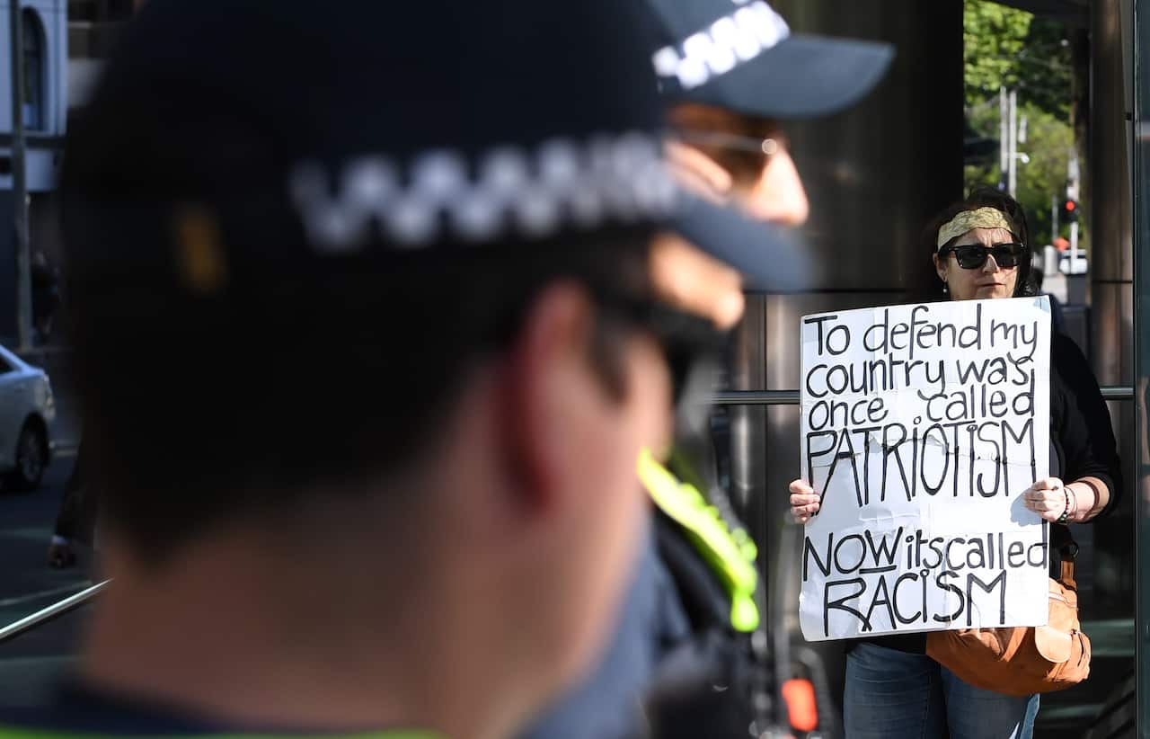 Police and a demonstrator outside the court during Cottrell’s appeal hearing.