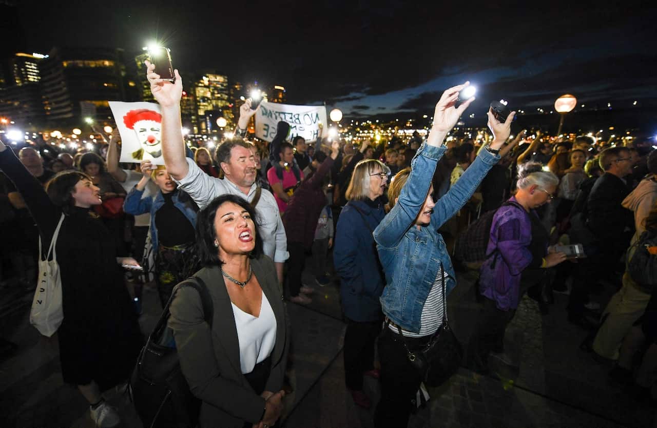 Demonstrators are seen protesting against the decision to project the barrier draw results for NSW Racing's multi million dollar race