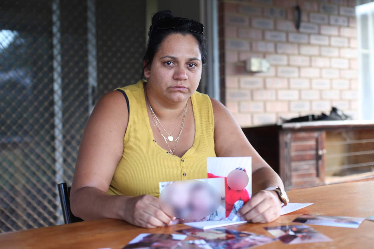Ms Wynne's cousin, Tseena Cooper, pictured holding photos of Ms Wynne. 