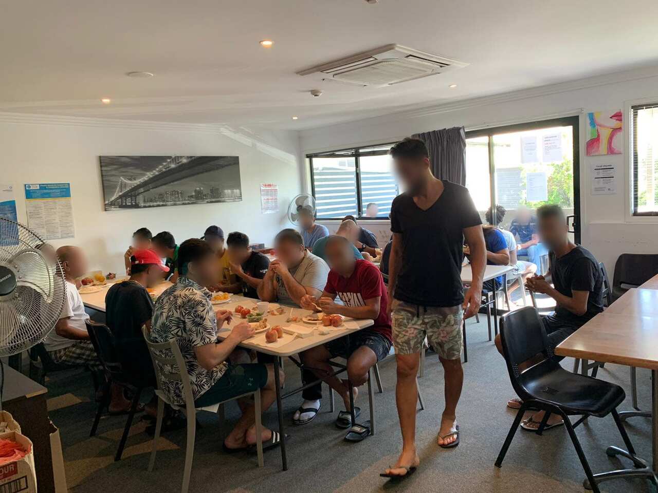 Hakeem and other detainees eat lunch in one confined space. 