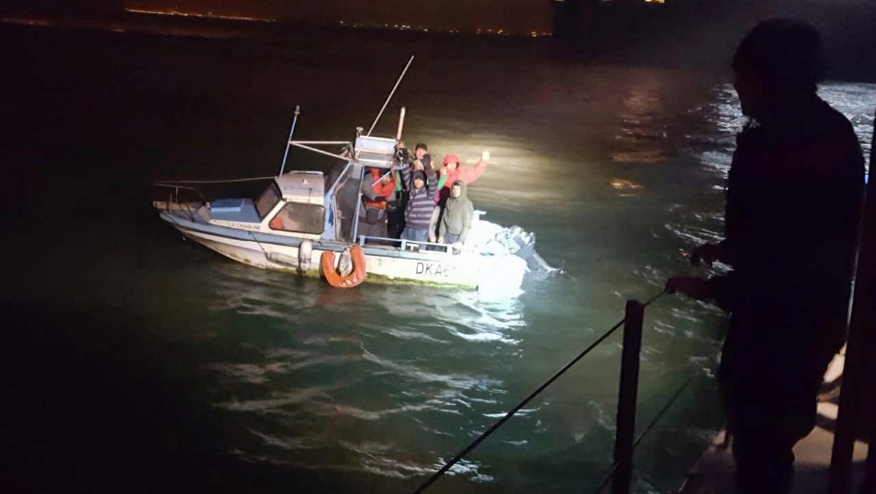 Migrants aboard a boat after being intercepted by French authorities, off the port of Dunkirk, northern France, on November 27, 2018.