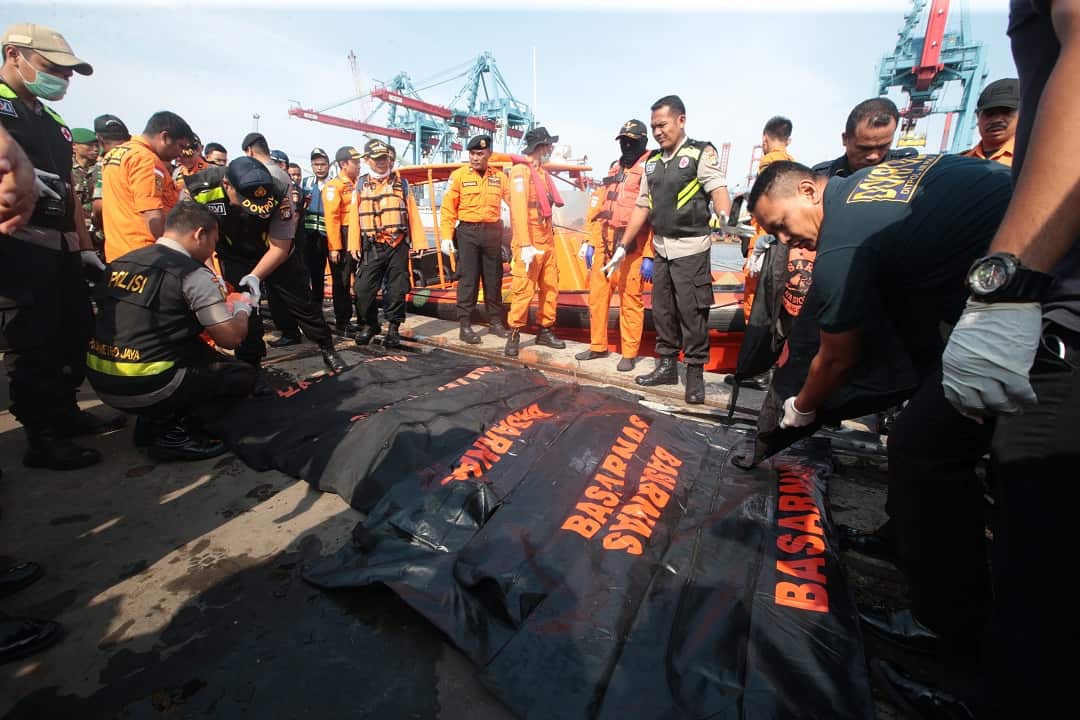 Indonesian rescue team members have retrieved body parts from the water where a plane crashed.