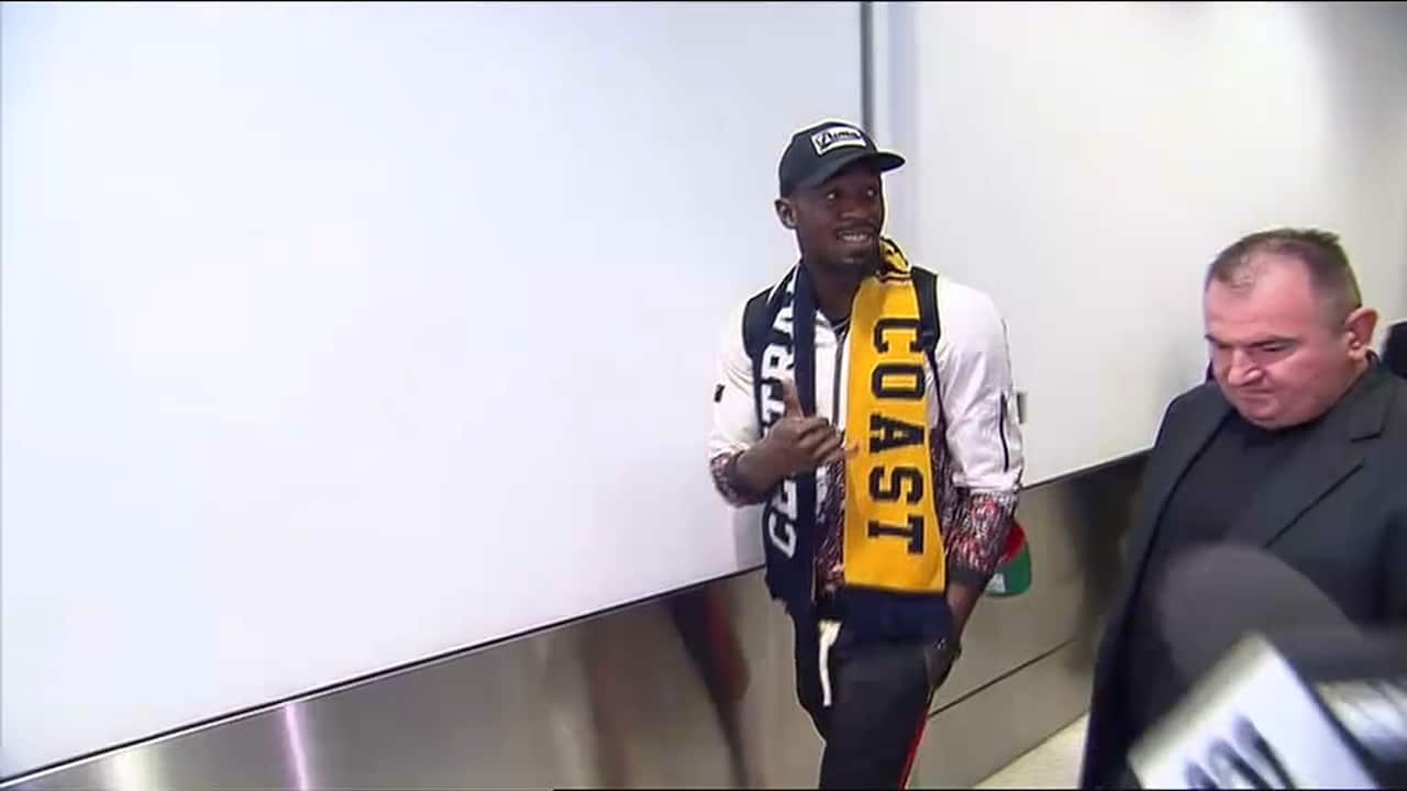 Usain Bolt is all smiles as he lands in Sydney before heading to the Mariners heartland  for an "indefinite training period".