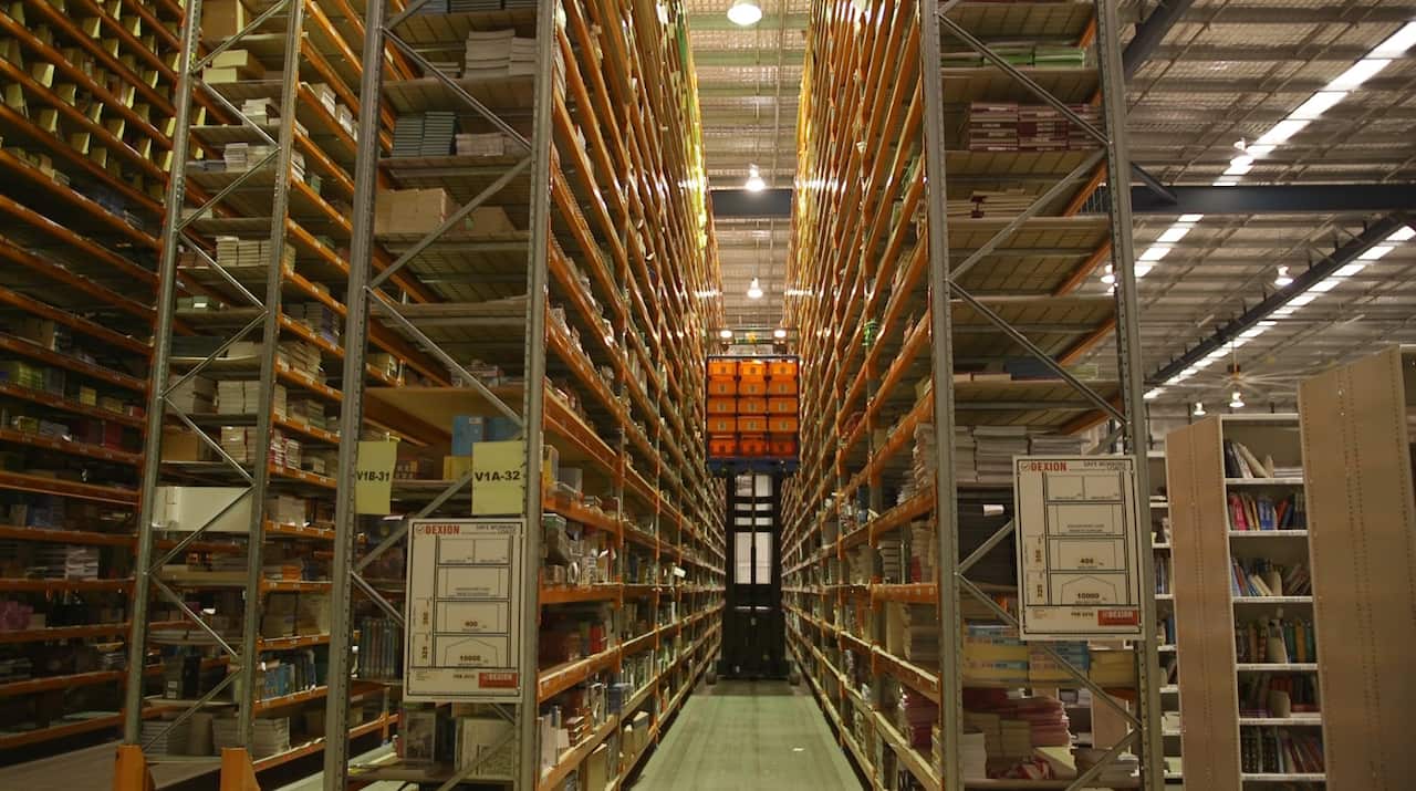 Workers retrieve books at Booktopia's warehouse.