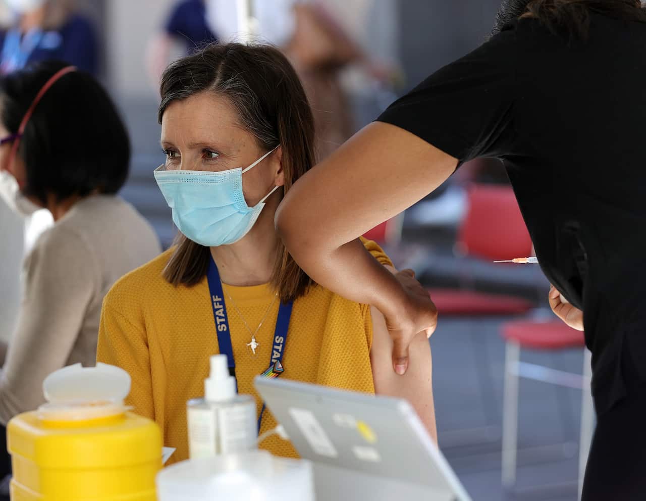 A woman is seen receiving her COVID-19 vaccination in Melbourne.