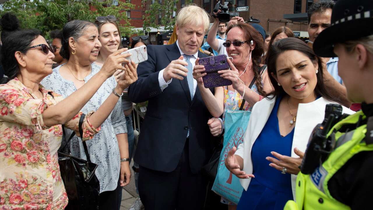 Britain's Prime Minister Boris Johnson and Home Secretary Priti Patel, second right, on a walkabout during a visit to North Road, Birmingham, England.