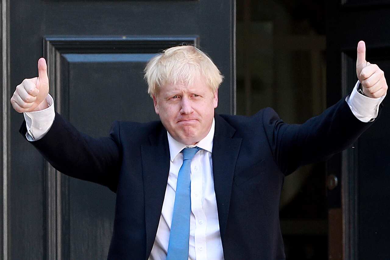 Newly elected Conservative party leader Boris Johnson poses outside the Conservative Leadership Headquarters