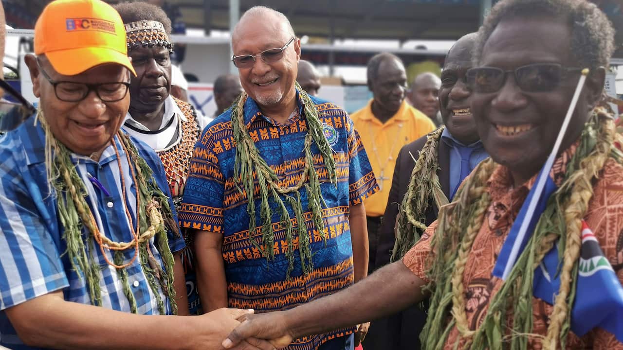 John Momis (left) the president of the Autonomous Region of Bougainville, shakes hands with Bougainville MP William Nakin in Buka, Papua New Guinea.