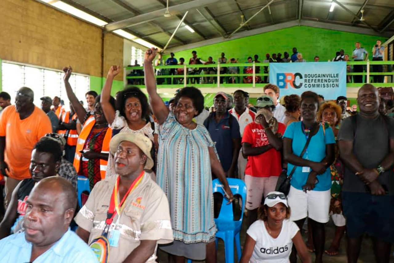 Members of the Bougainville Women's Federation cheer after hearing the results from an independence referendum.