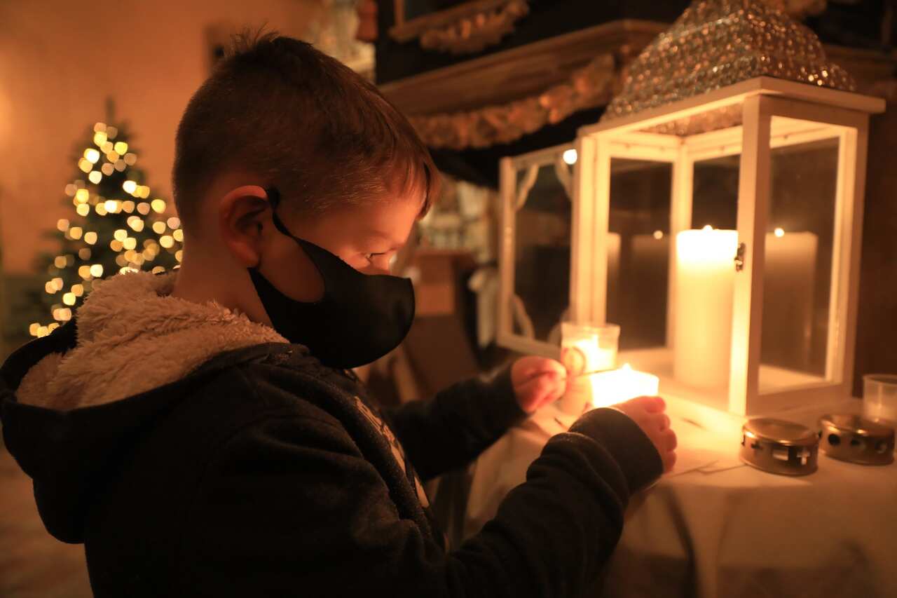 A boy fetches the light of peace at the Protestant St. Peter's Church in Saxony-Anhalt, Beyendorf, Germany.