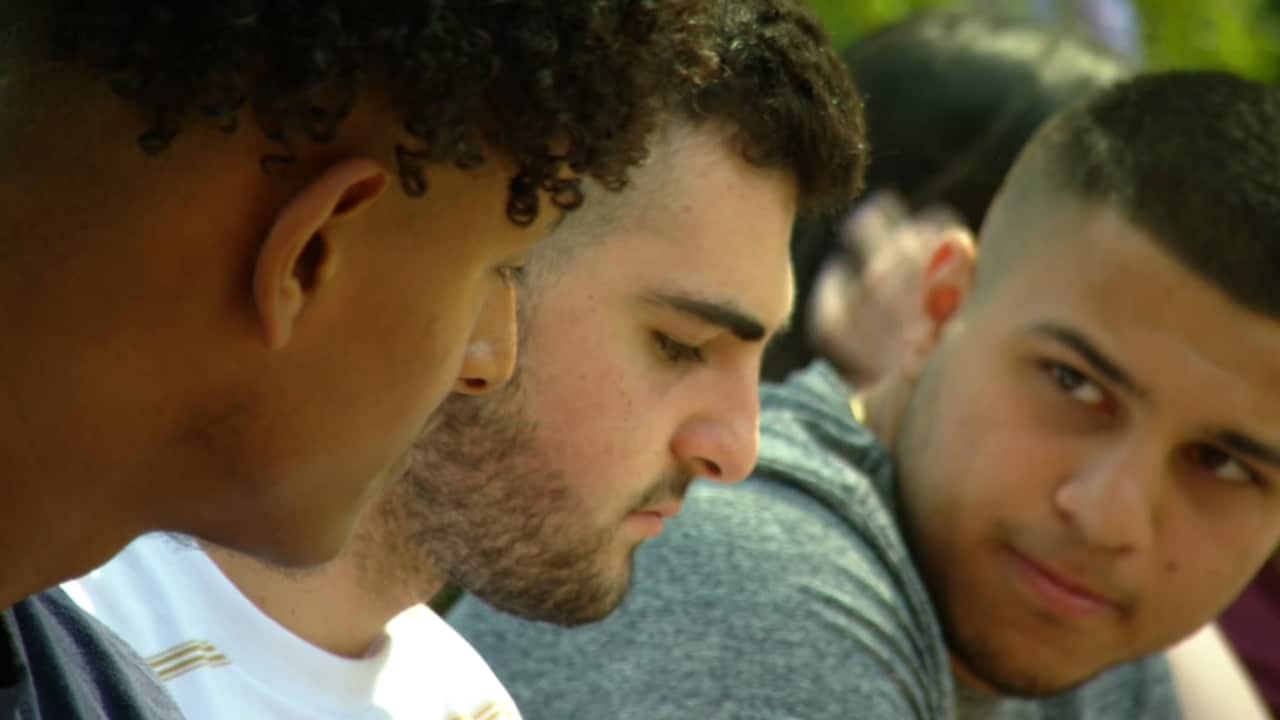 Student Miguel Hanein (R) speaking with his peers.