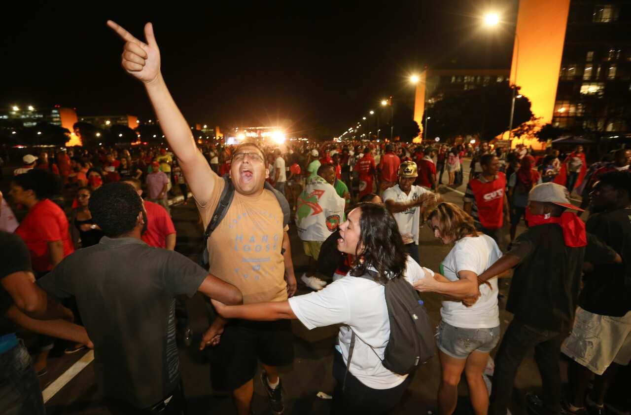 A man gets pulled back during the demonstrations (Getty)