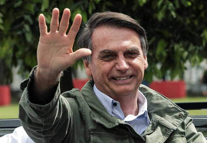 Brazilian far-right presidential candidate Jair Bolsonaro greets supporters after voting. He's now been announced as the president-elect.