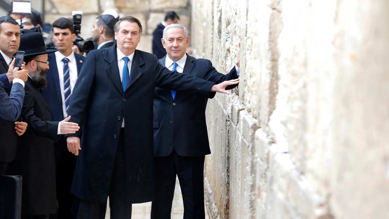 Brazilian President Jair Bolsonaro and Israeli Prime Minister Benjamin Netanyahu touch the Western wall, in the Old City of Jerusalem.