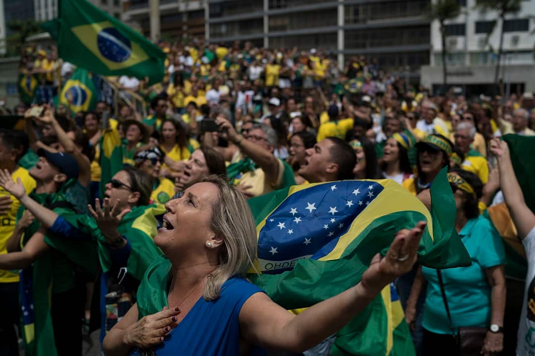 Supporters of Jair Bolsonaro sing Brazil's national anthem during a campaign rally.