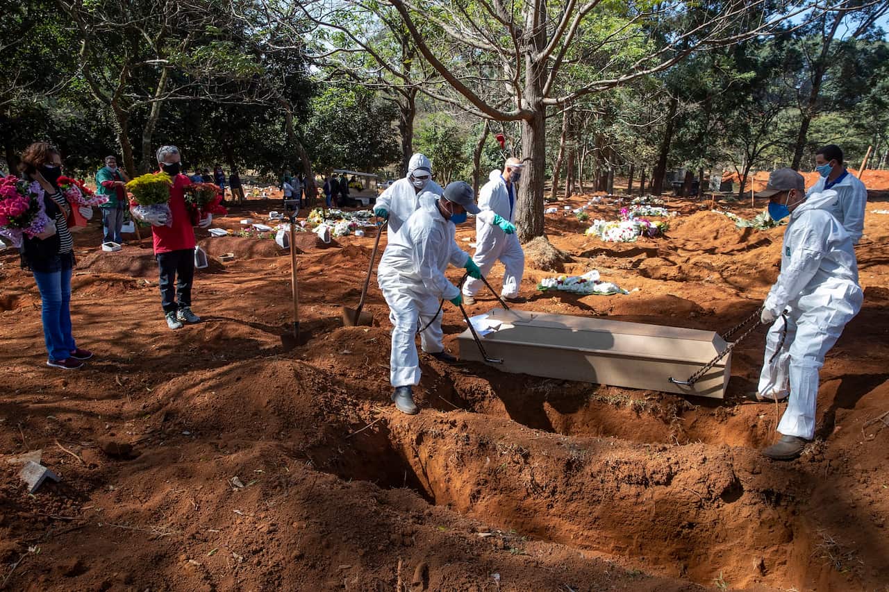 Cemetery workers in protective clothing bury the bodies of COVID-19 victims at the Vila Formosa cemetery in Sao Paulo, Brazil.
