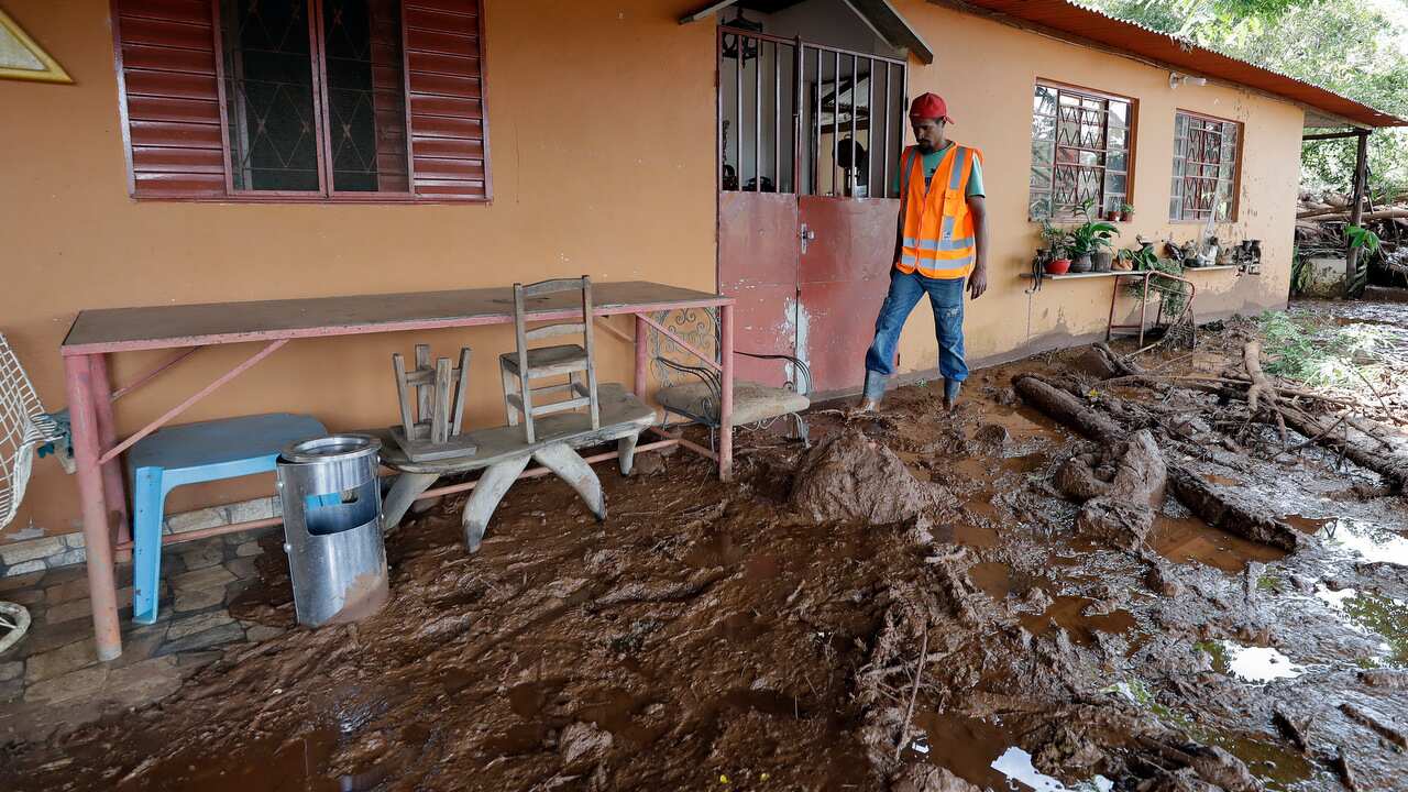 A volunteer walks next to a partially destroyed home, two days after a dam collapsed in Brumadinho, Brazil.