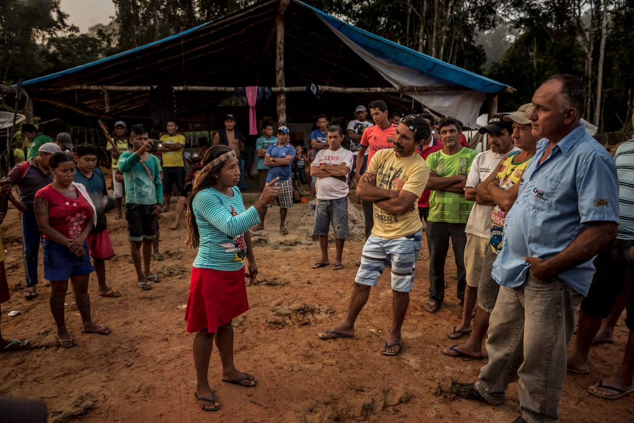 Members of the indigenous Munduruku tribe confront the illegal gold miners and their camp supervisor, Amarildo Dias Nascimento, far right, who argued that his men had few work options and were merely trying to survive, in the Amazon rainforest in Brazil.