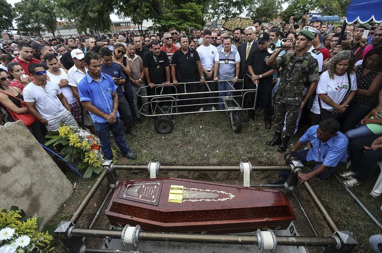 A large crowd of mourners attend the funeral of policeman Mario Marcelo Albuquerque, who was killed in the line of duty in Serra, Espirito Santo. 