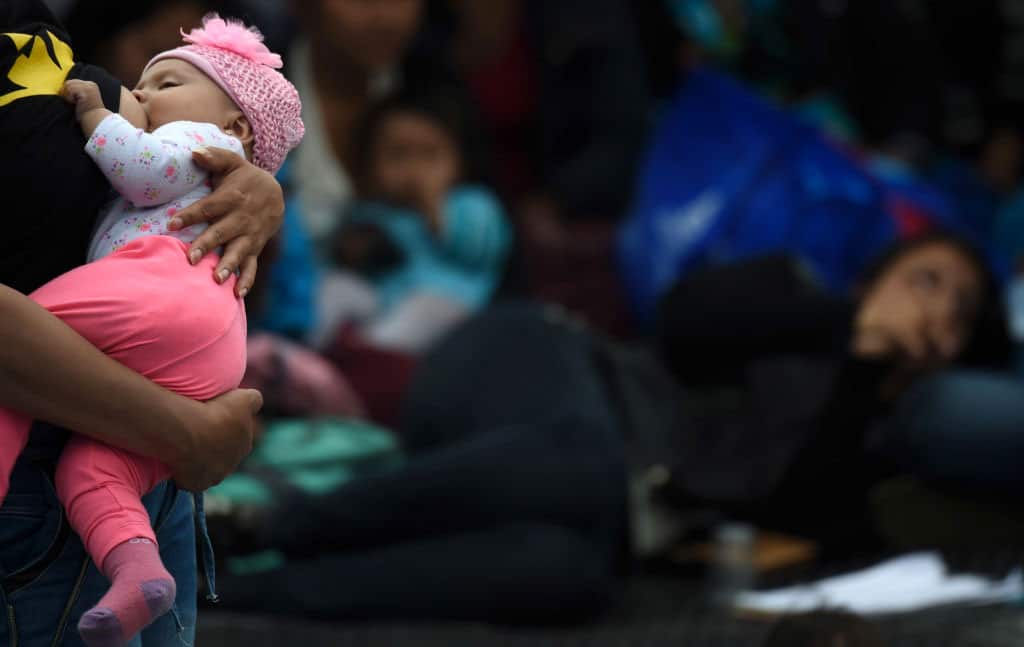 A woman breastfeeds her baby, during a public event to promote the benefits of breastfeeding, at a park in Bogota on November 3, 2017.