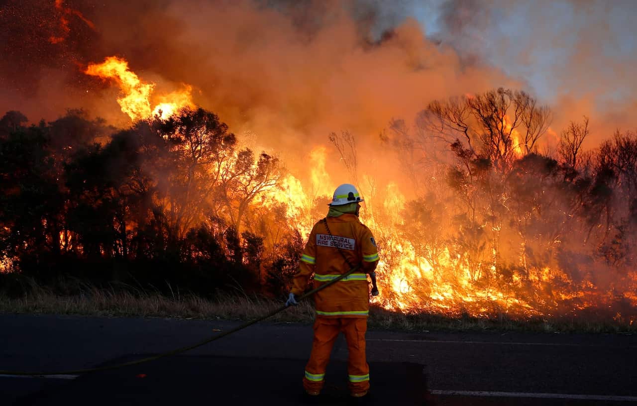 Fire crews back burn areas of bushland at Salt Ash, in the NSW Hunter region, on Sunday, August 19, 2018.