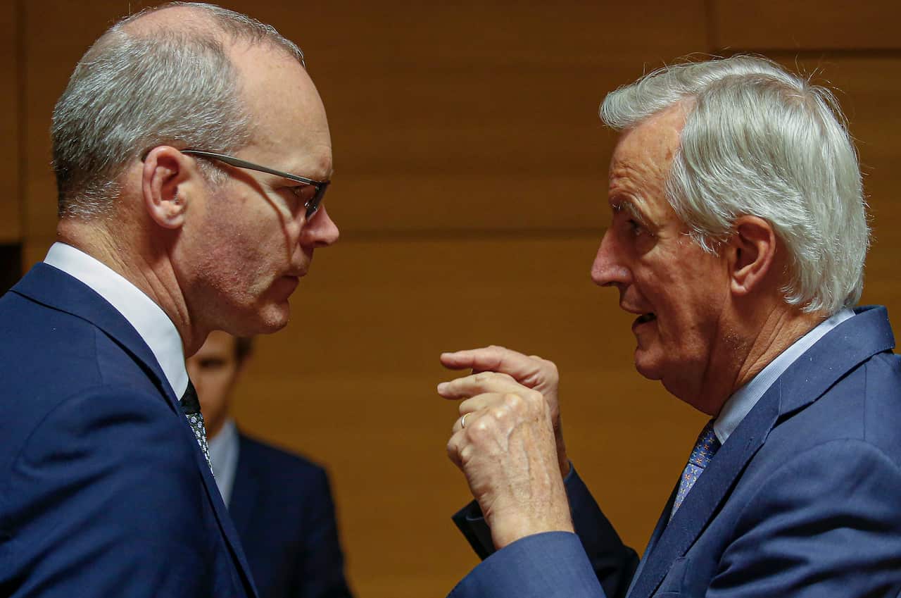 Irish Foreign Minister Simon Coveney(left) talks with the European Union's chief Brexit negotiator Michel Barnier (right).  