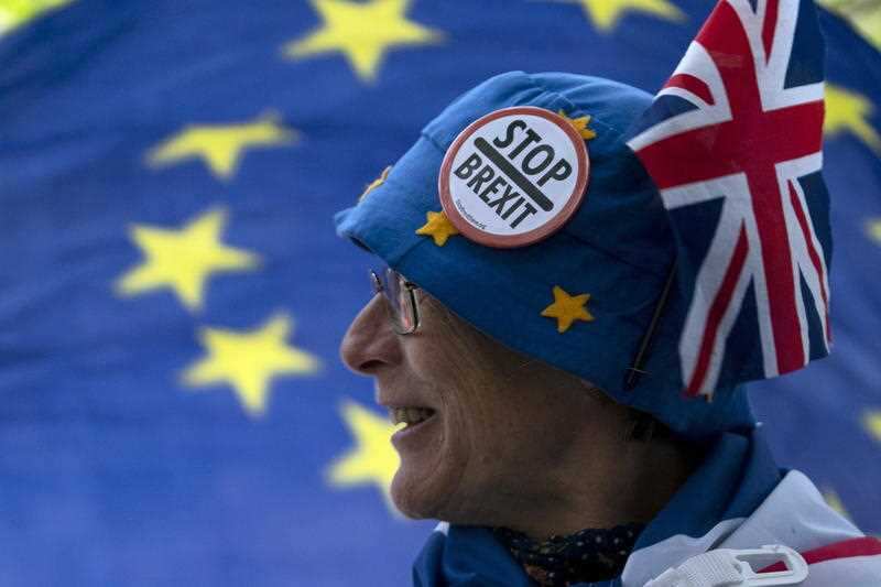 An anti Brexit protester stands outside the Houses of Parliament in London.