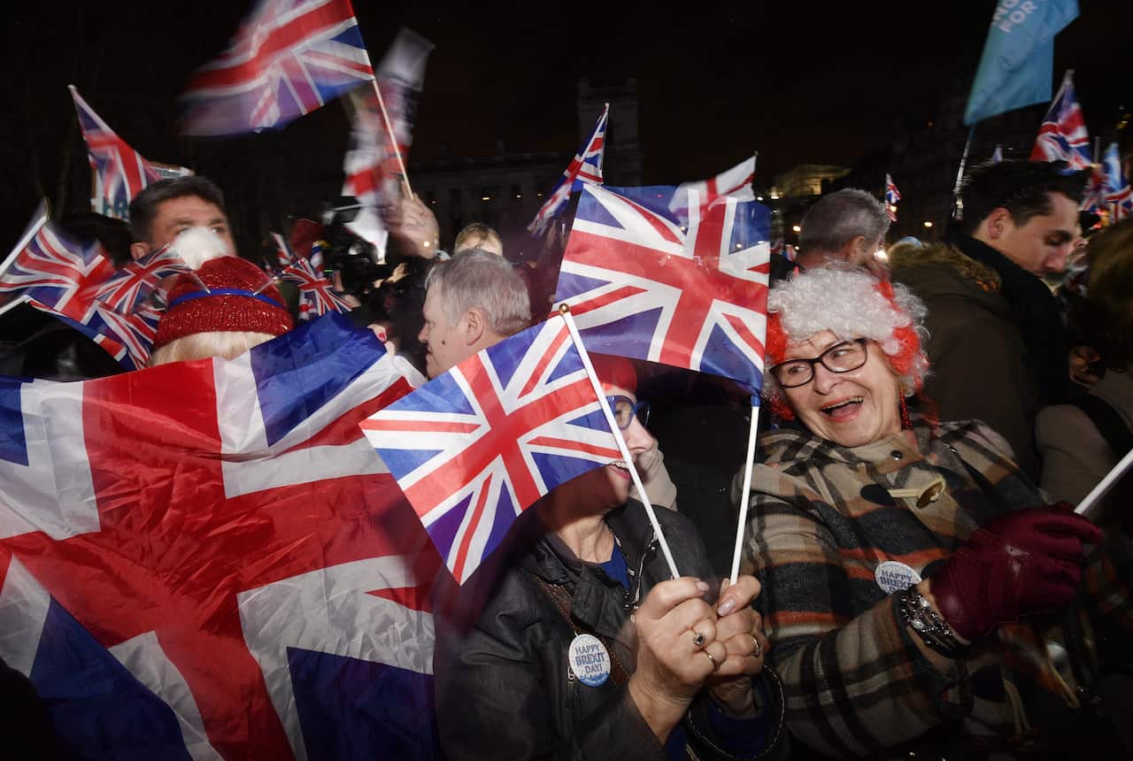 Pro-Brexit supporters celebrate after the UK officially leaves the EU, outside the Houses of Parliament in London.