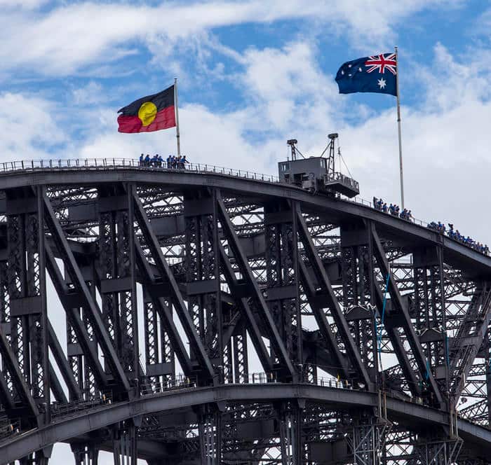 The Australian and the Aboriginal flag fly together on the Sydney Harbour Bridge for the first time ever on Australia Day, 2013.