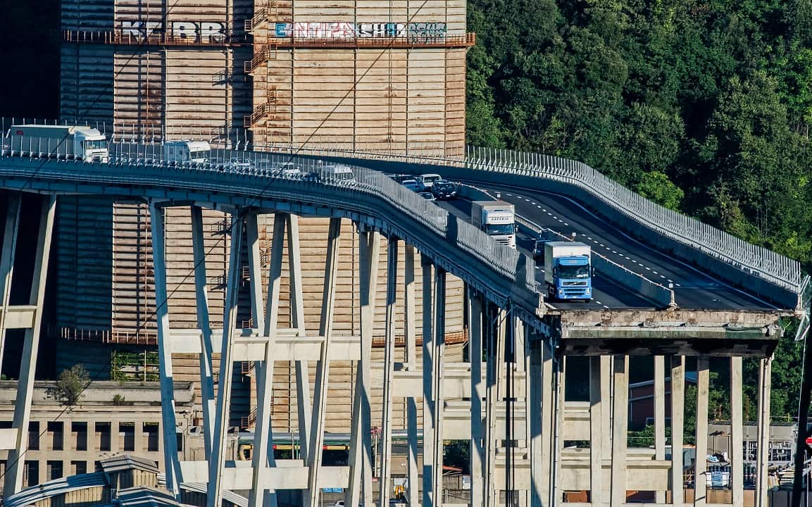Cars and trucks are left on a section of the collapsed Morandi highway bridge in Genoa.
