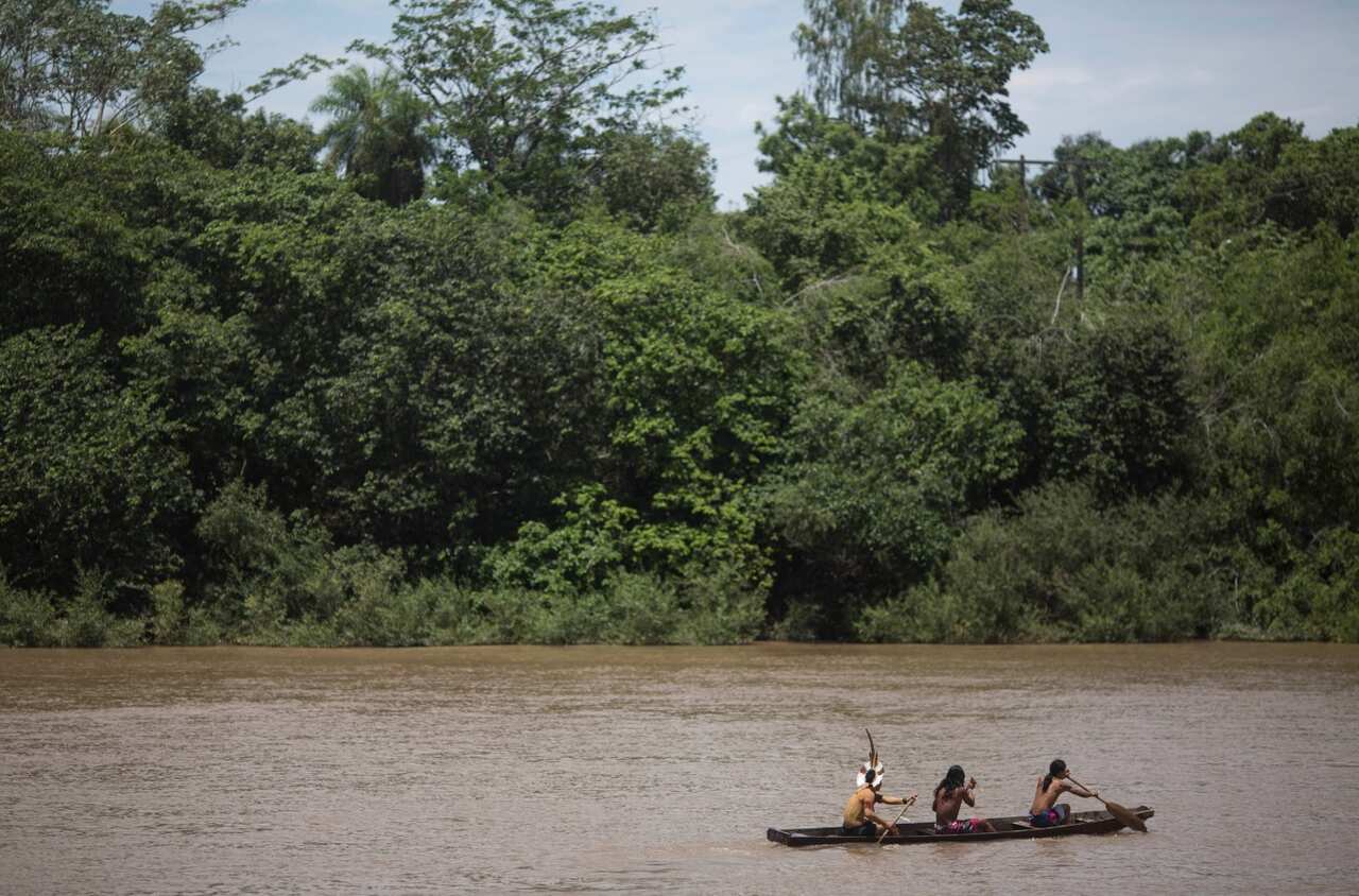 Indians paddle before racing in the canoeing event at the Indigenous Games in Cuiaba, Brazil