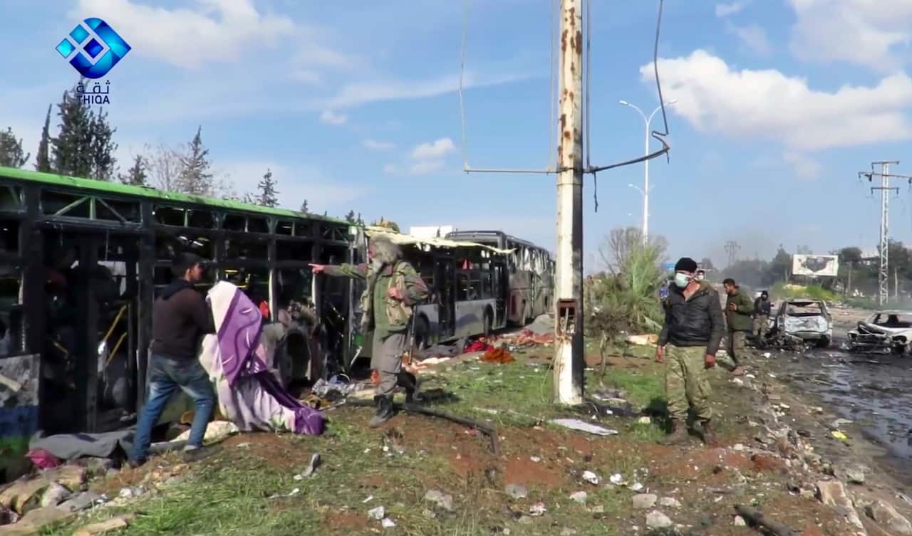 A handout photo made available by Thiqa News Agency (TNA) showing rescue and media personnel at the scene of a car bomb attack (AAP)