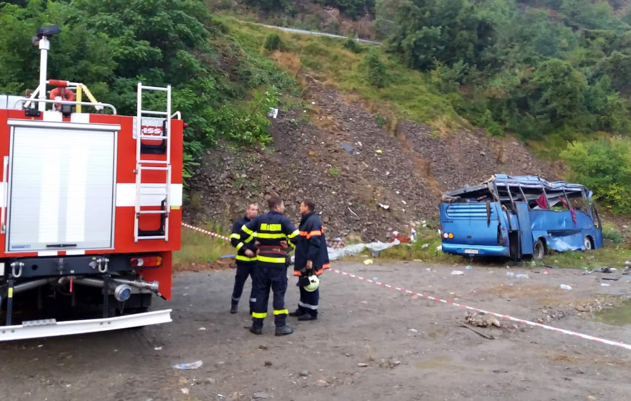A handout photo made available by the Bulgarian Ministry of the Interior press office on 25 August 2018 shows a bus (R) crashed