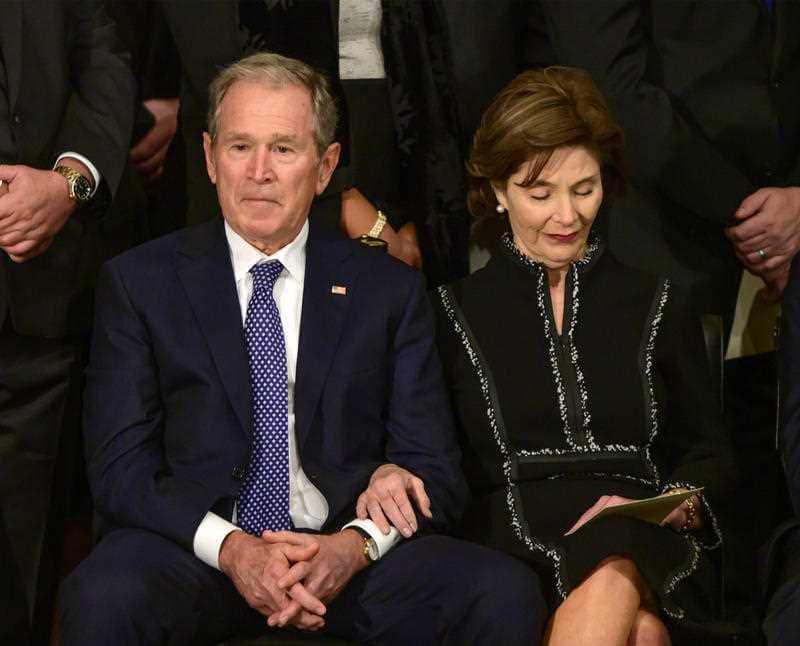 Former United States President George W Bush and former first lady Laura Bush listen to the speakers during the ceremony. 