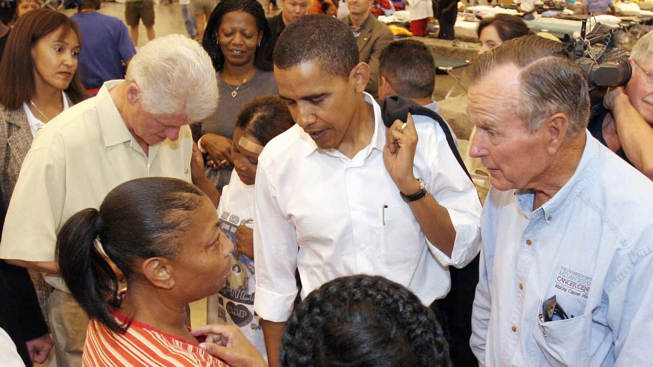 Former US presidents Bill Cinton, George Bush and then senator Barack Obama visit with people at a shelter set up for Hurricane Katrina evacuees in 2005.  