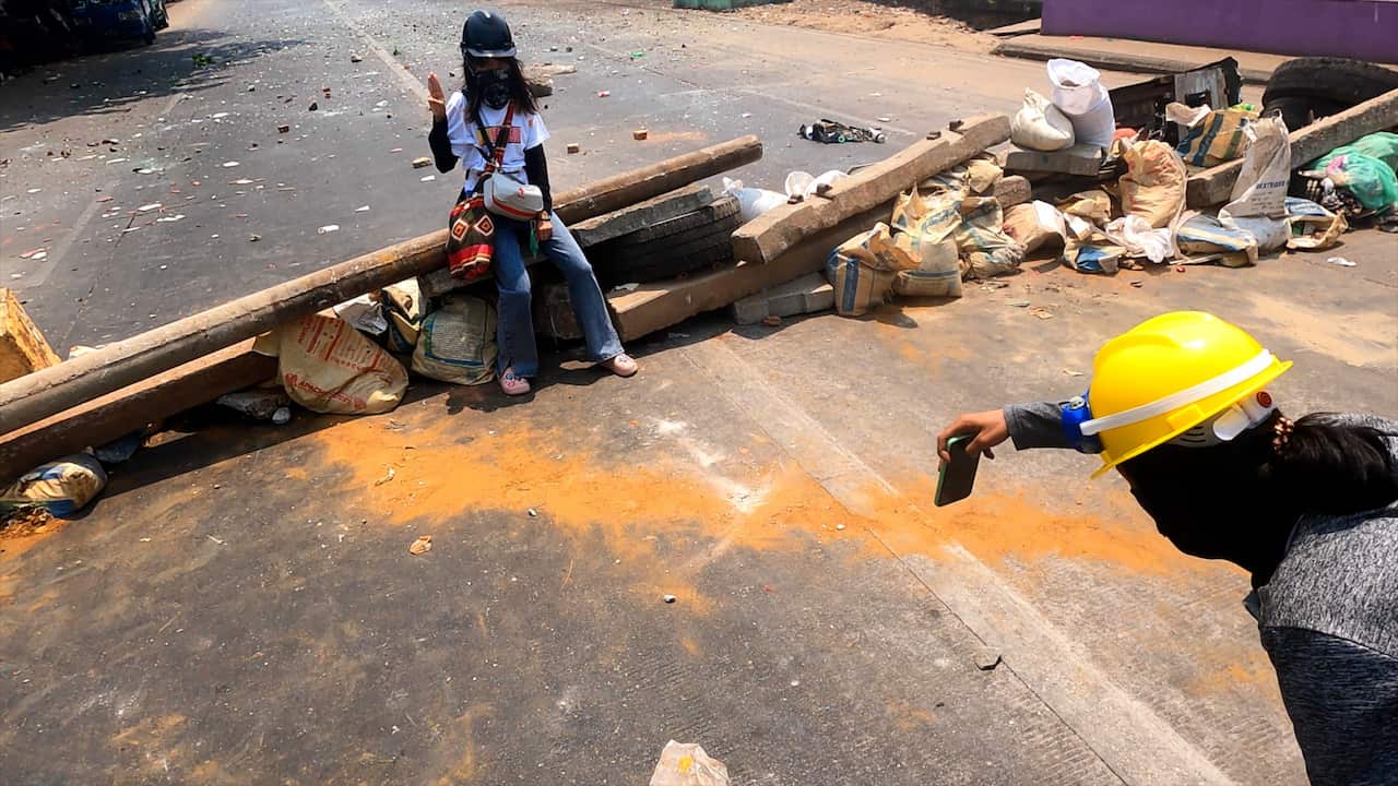 Cindy gives the three-finger salute which has become a symbol of resistance against the military coup.