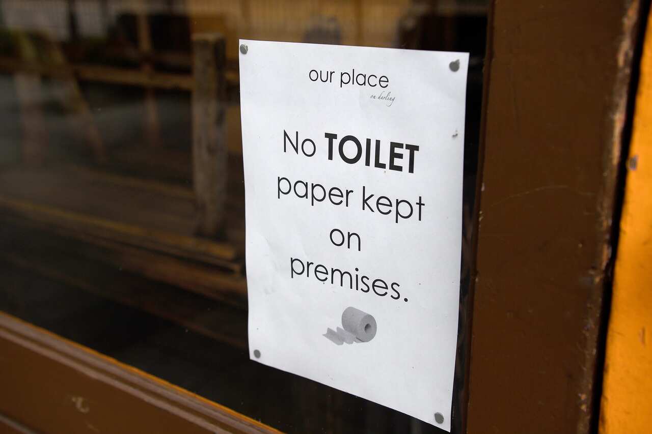 Signage is seen on the entry of Our Place cafe in Balmain Woolworths, Sydney, Saturday, March 7, 2020. Australians are stockpiling toilet paper over Coronavirus fears. (AAP Image/Bianca De Marchi) NO ARCHIVING