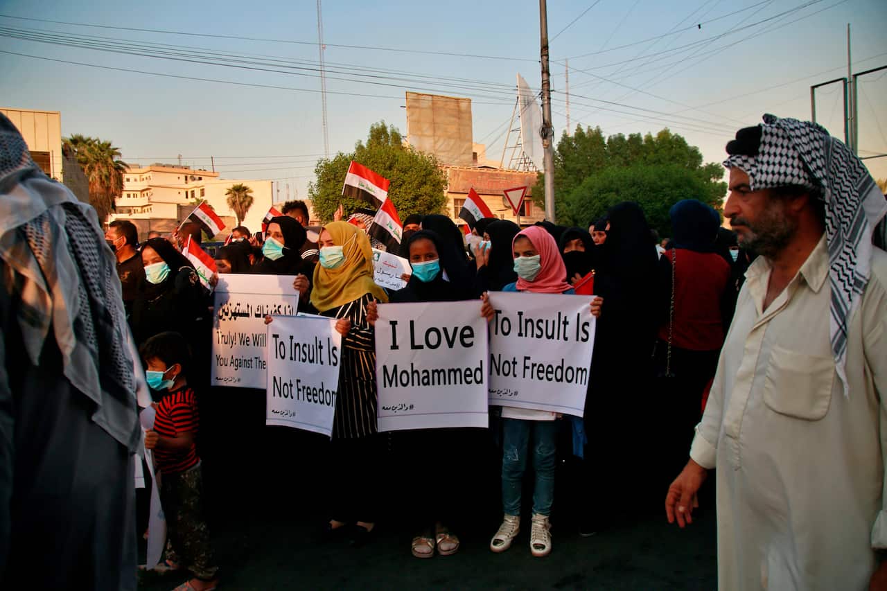 Demonstrators gather to protest Paris-based magazine Charlie Hebdo's decision to republish cartoons of the Prophet Mohammad near of the French embassy in Baghdad, Iraq, Thursday, Sept. 17, 2020. (AP Photo/Khalid Mohammed)