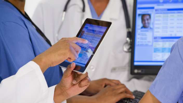 Medical staff use a tablet computer